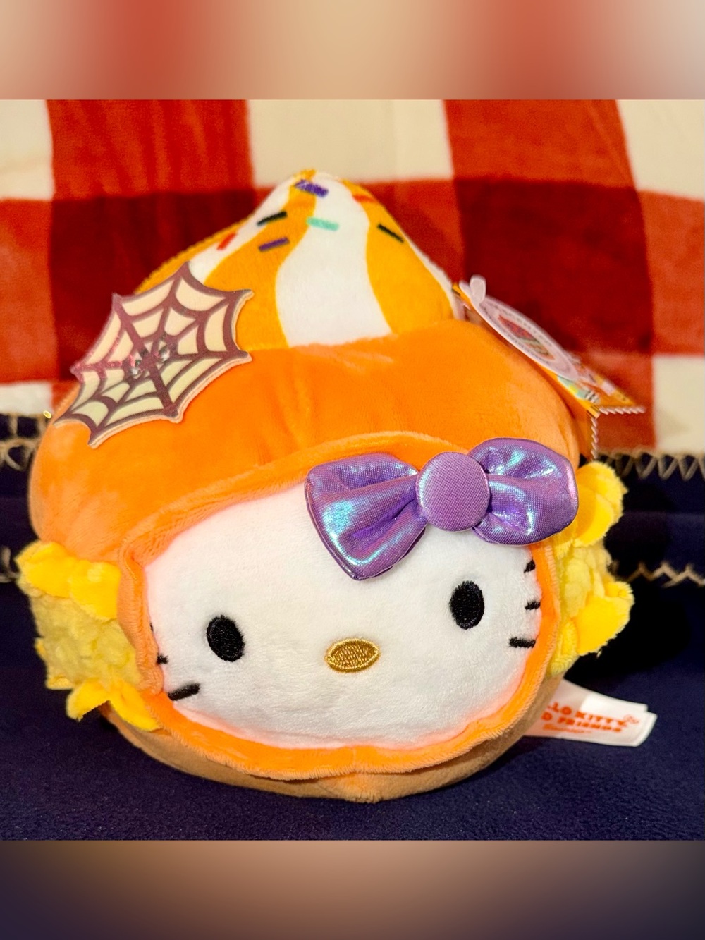 Sanrio Hello Kitty Plush in Orange Candy Corn Outfit with Shiny Purple Bow